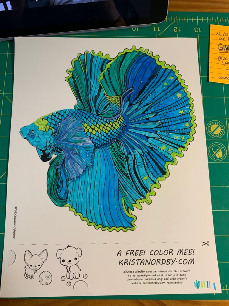 A colorful illustration of a betta fish featured on a printable coloring page, surrounded by a decorative border and text that encourages coloring. Includes small drawings of a fox and a dog at the bottom, with a website link for download.